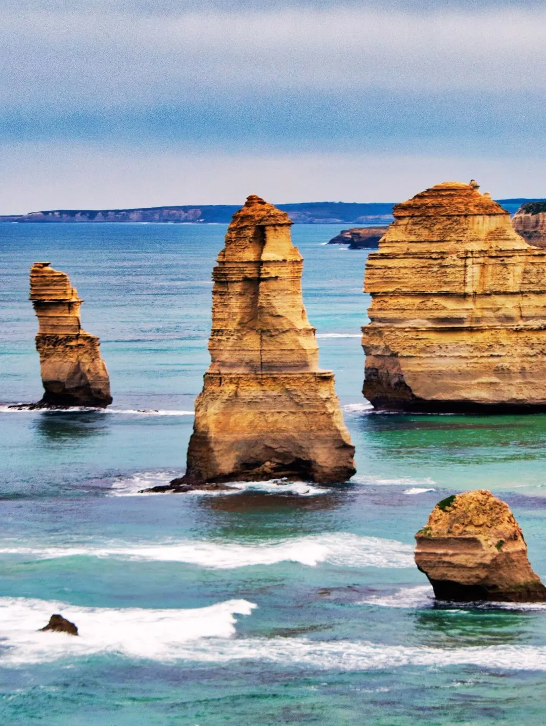 An image of 4 of the limestone pillars of 12 Apostles in Great Ocean Road, daytime, 3x4 aspect ratio.